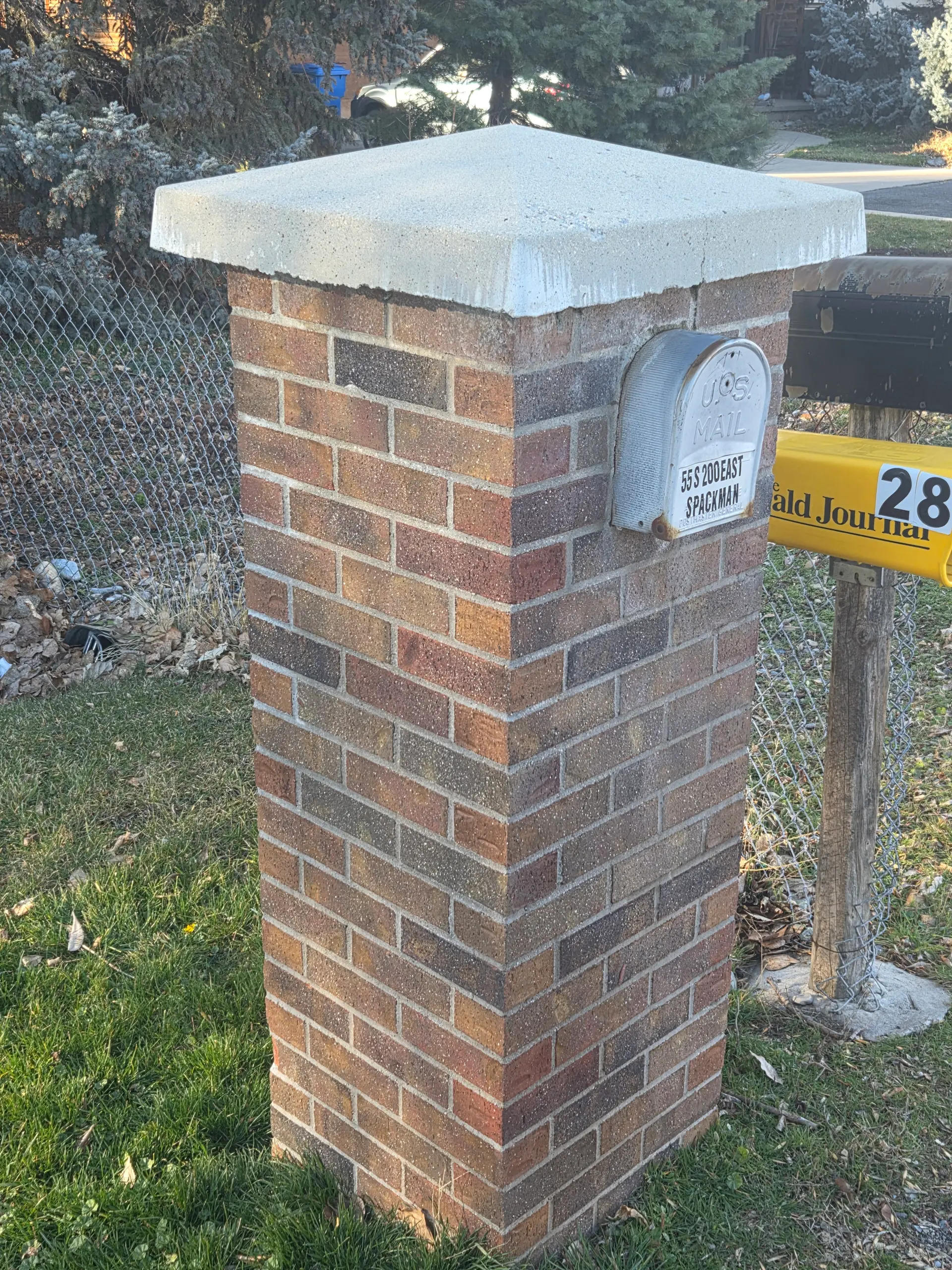 Custom brick mailbox column with concrete cap by Spackman Construction Services