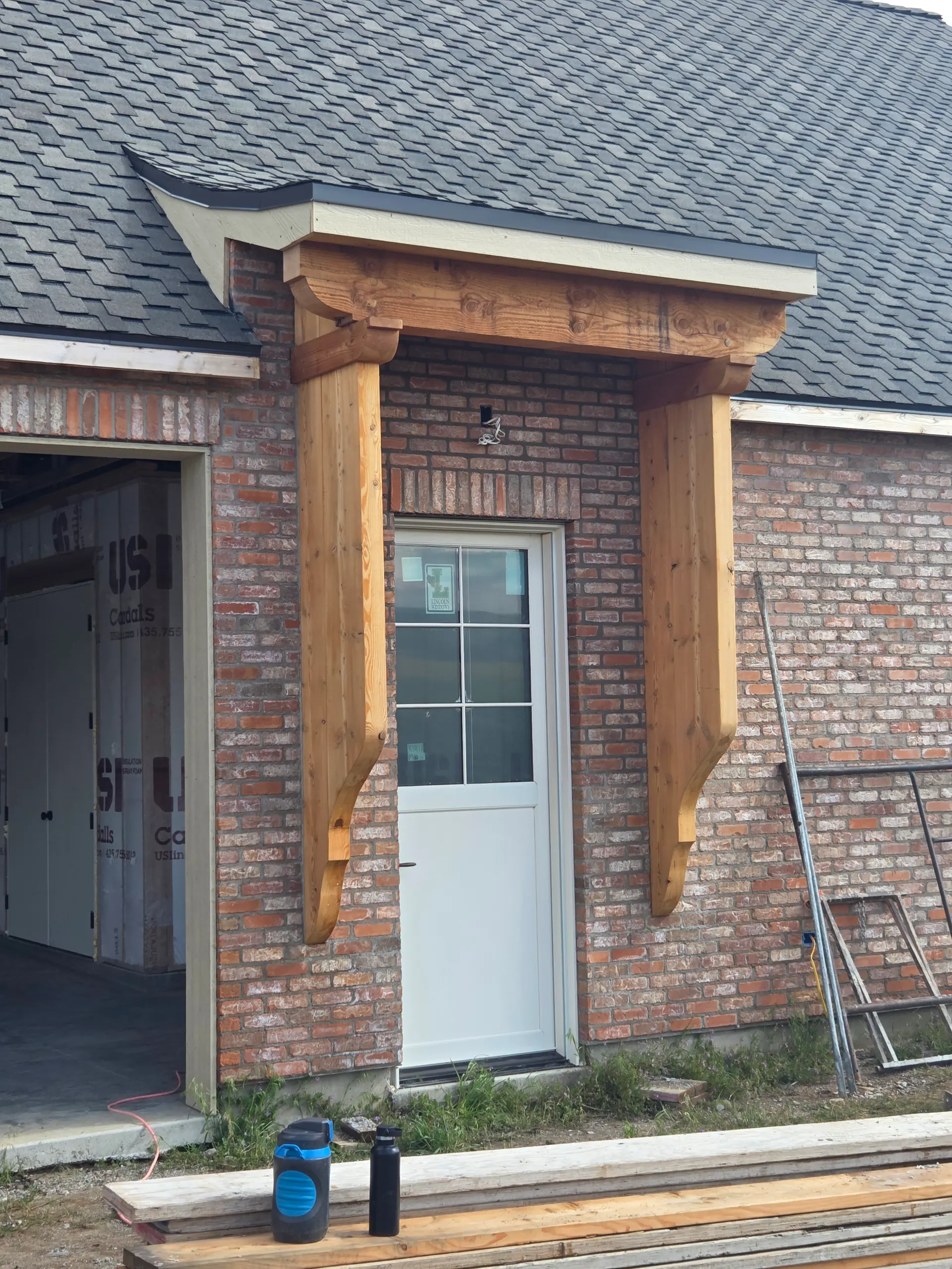 Brick door alcove with cedar timber accents by Spackman Construction Services